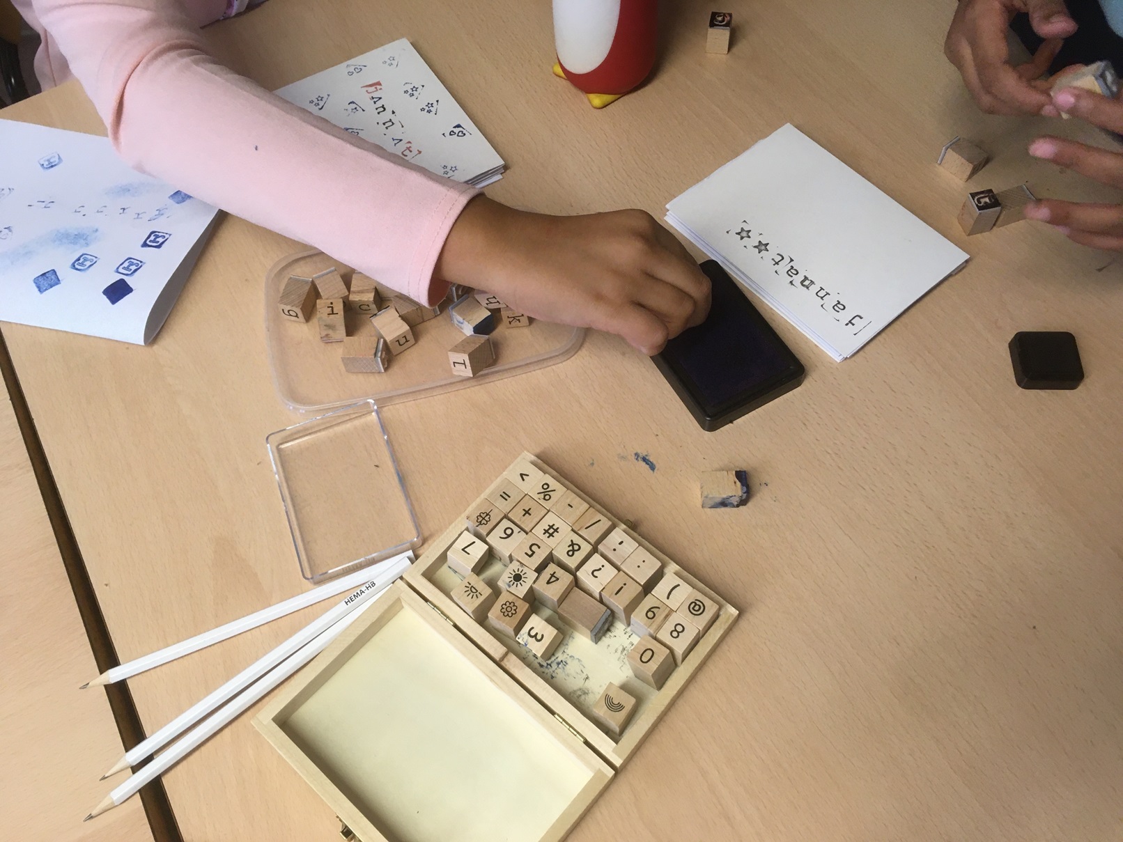 table avec mains d'enfants utilisant des cachets